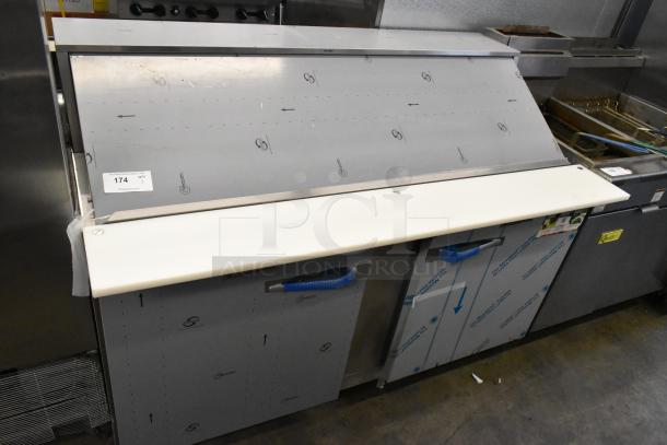 2020 Traulsen UPT6024-LR stainless steel prep table. Scratch and dent condition, with protective film and label visible.