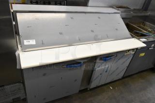 2020 Traulsen UPT6024-LR stainless steel prep table. Scratch and dent condition, with protective film and label visible.
