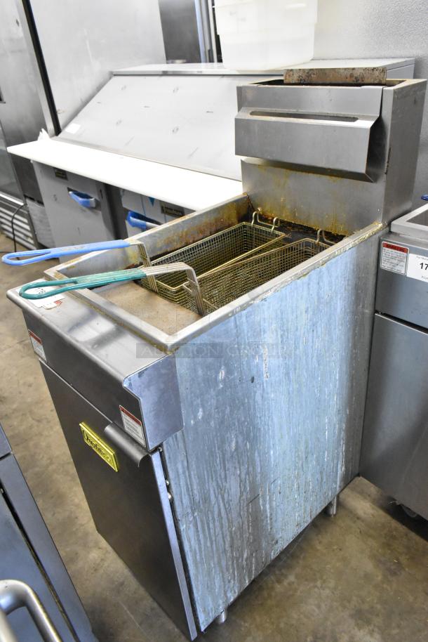 Qualite QL-9/NG stainless steel deep fryer, 90,000 BTU, includes 2 metal fry baskets, shows signs of use.
