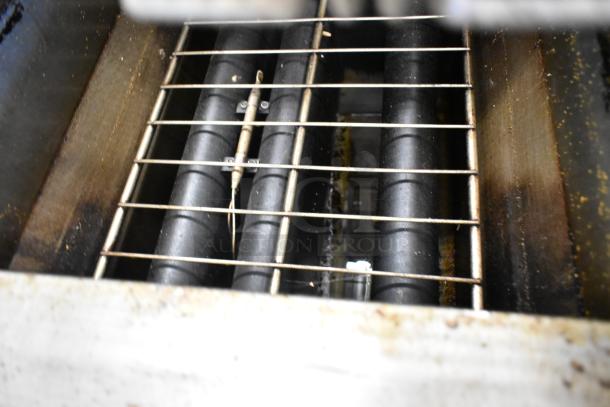 Qualite QL-9/NG stainless steel deep fat fryer, 90,000 BTU, with visible heating elements and natural gas connections.