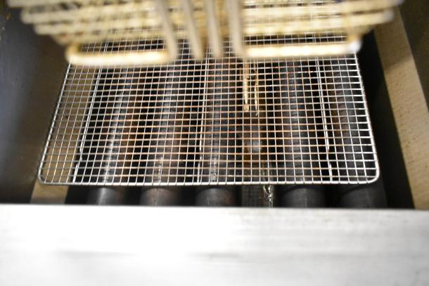 Cook Rite ATFS-75 stainless steel fryer interior with visible heating elements. Comes with 3 metal fry baskets. 170,000 BTU.