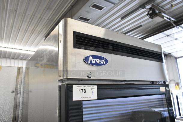 2019 Atosa MCF8570GR stainless steel commercial single door freezer on casters, features a visible Atosa logo and auction tag.