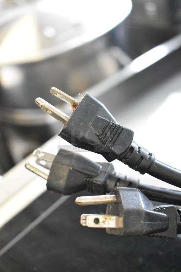 Three Centaur InductionRange plugs in fair condition, stainless steel countertop single burner, 120 volts, 1 phase.