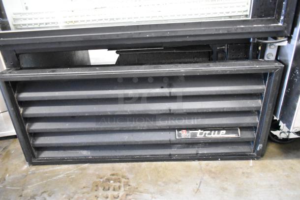 True GDM-26 commercial single door cooler merchandiser. Features poly coated racks, 115V, 1 Phase. Visible True logo.
