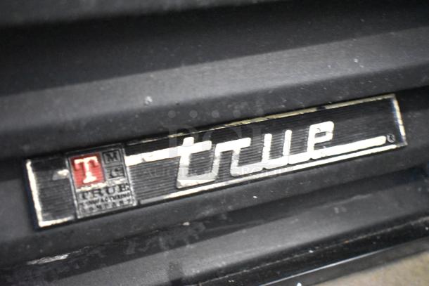 True GDM-26 metal single door reach-in cooler. Features poly-coated racks, 115 volts, 1 phase. Label with logo visible.