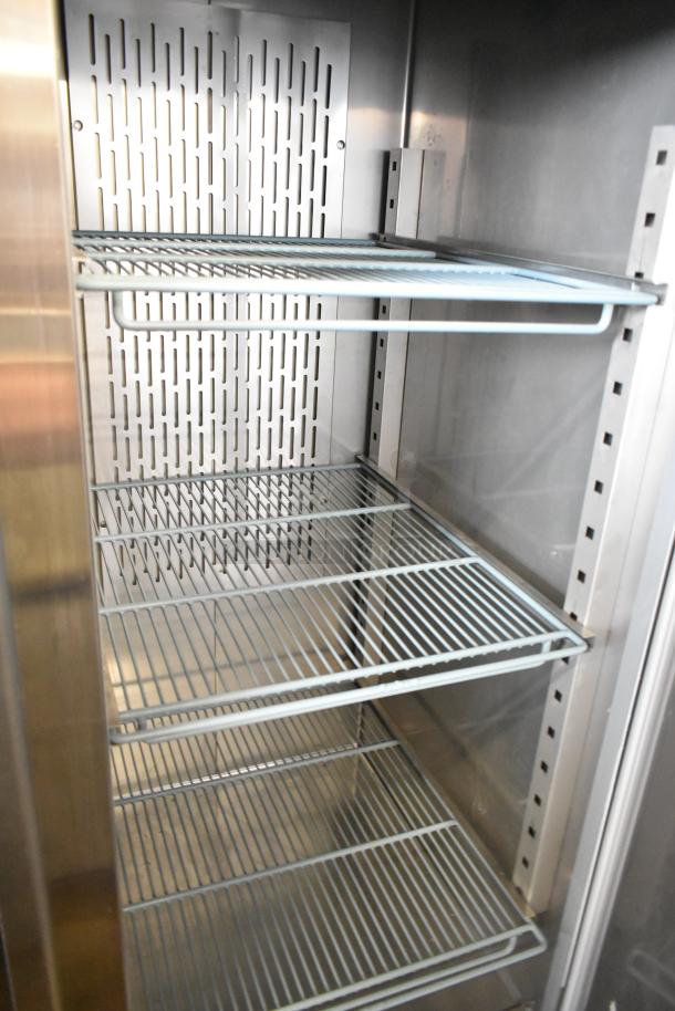 Avantco 178SS2FHC stainless steel 2-door reach-in freezer with poly-coated racks, on commercial casters.