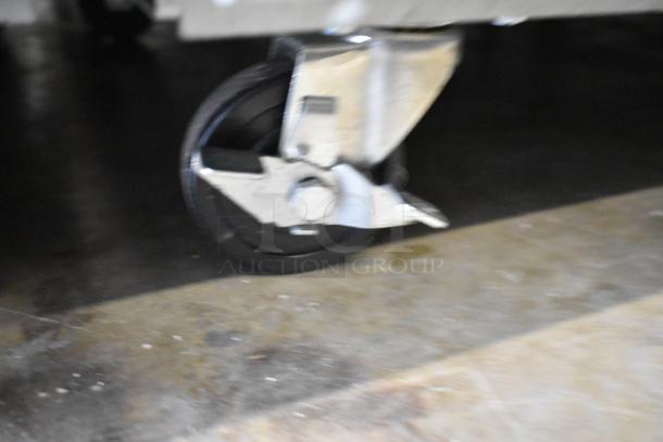 Close-up of a commercial caster on the Avantco 178SS2FHC stainless steel freezer, showing sturdy metal construction.