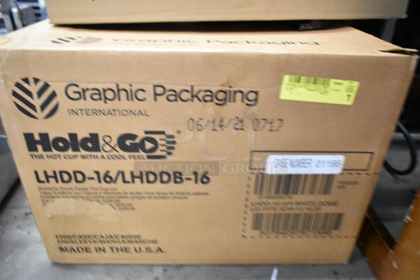 Two boxes labeled "Graphic Packaging International" with LHDD-16/LHDDB-16, includes luxury dining kit plasticware, made in USA.