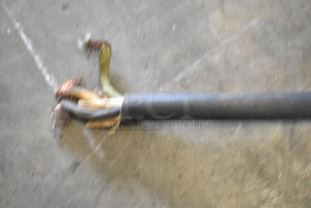 Damaged electrical cable of a Star Pro Max UG281 Panini Press, showing exposed wires on a concrete surface.