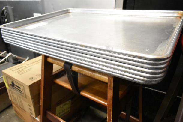 Stack of 7 full-size metal baking pans, slightly worn. Perfect for commercial baking, auction offers 7 times your bid.