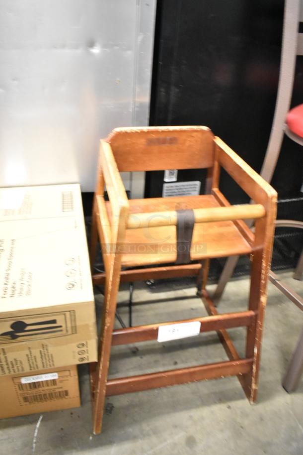 Wooden high chair with visible wear and a safety strap, part of a lot of 19 assorted chairs including bar and dining height.