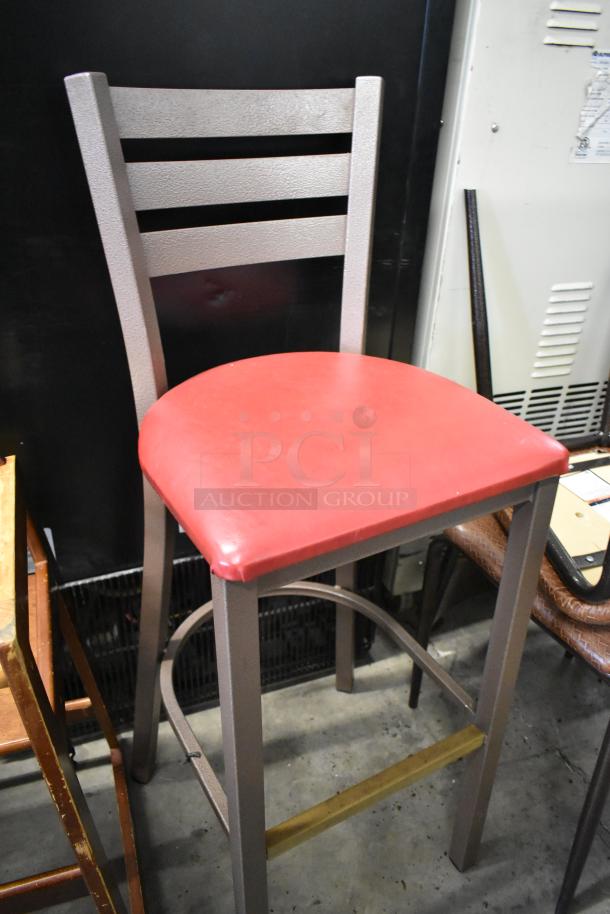 A bar height chair with a red seat and metal frame, part of a 19-piece chair set including high and dining chair varieties.