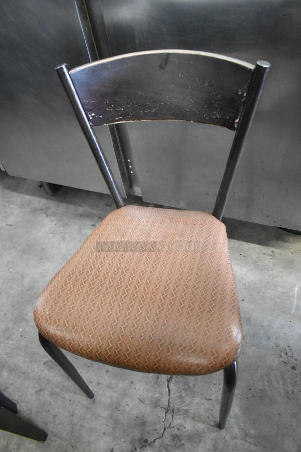 Vintage dining chair with black metal frame, brown fabric seat, and worn finish. Part of a lot of 19 assorted chairs.