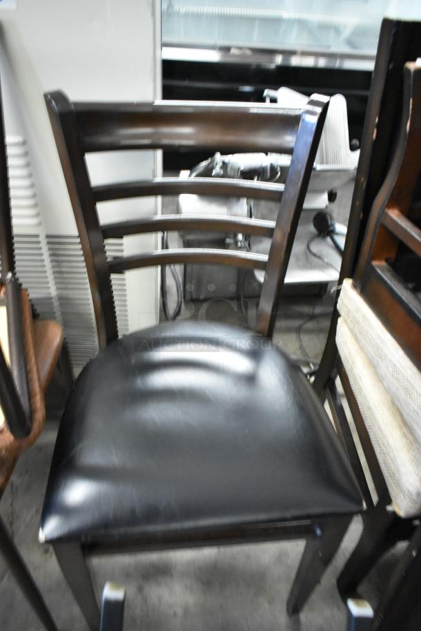 19 assorted chairs including a high chair, bar height chair, and dining chairs. Features dark wood and leather seat.