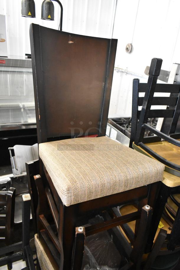 Stacked chairs including a high chair with brown wooden back and striped cushioned seat, auction item, used condition.
