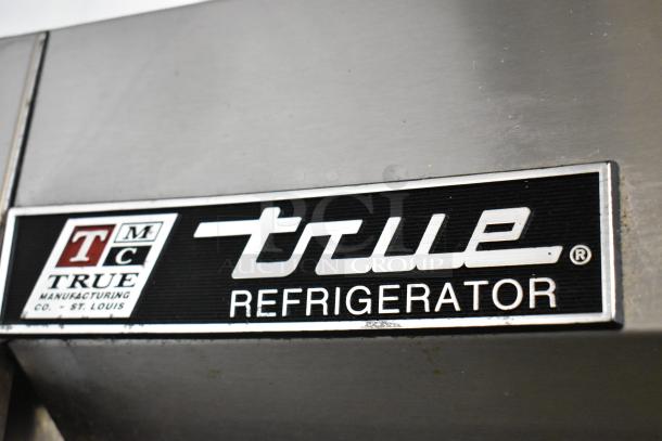 True T-49 stainless steel commercial cooler label, indicating model and manufacturer, with visible brand logo.