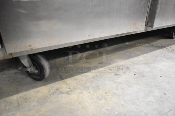 Beverage Air EF48-1AS stainless steel 2-door commercial freezer on casters, showing wear. Includes poly-coated racks.