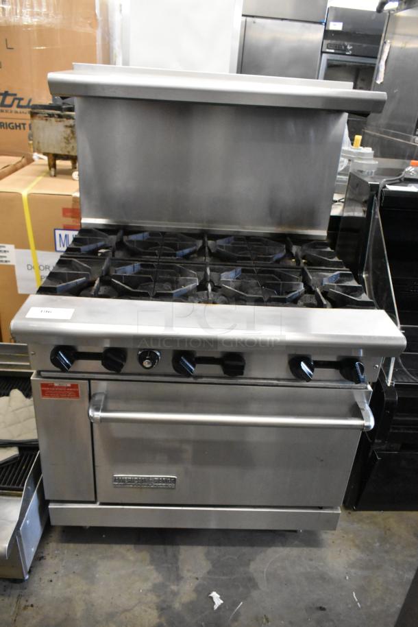 American Range stainless steel commercial gas-powered range with 6 burners, oven, overshelf, and backsplash. Good condition.