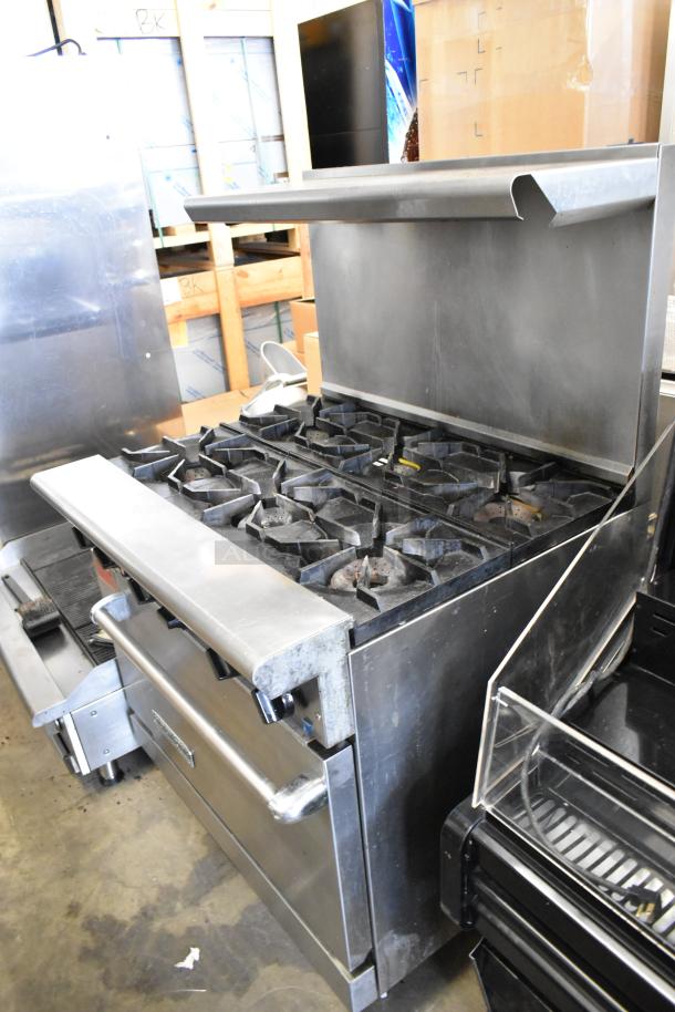 American Range stainless steel commercial gas 6-burner range with oven, over shelf, and backsplash; used condition.