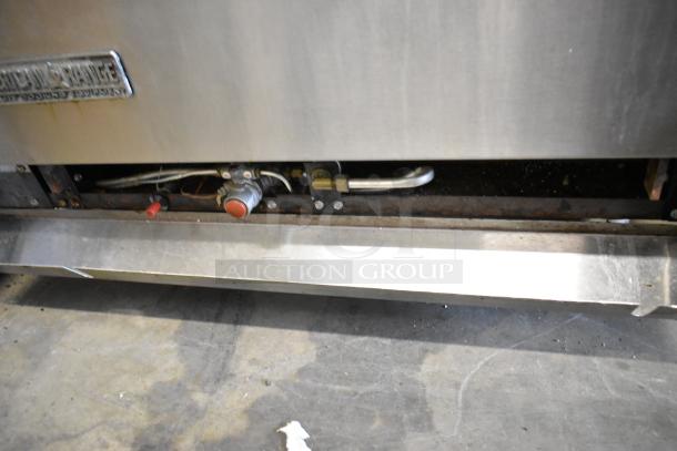 American Range stainless steel commercial gas 6 burner range, featuring an oven, over shelf, and backsplash, in used condition.