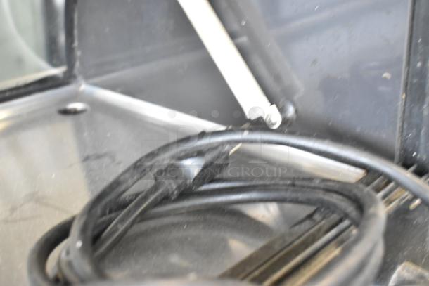 Hoshizaki HNC-180BA-L-S sushi display case interior, showing a coiled power cord. Visible stainless steel surfaces.