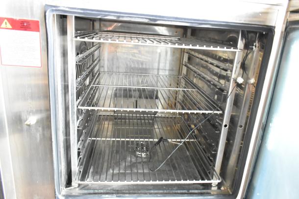 Stainless steel Alto Shaam CTP7-20E electric combi oven on equipment stand, 208-240V, 3 phase. Interior racks visible.