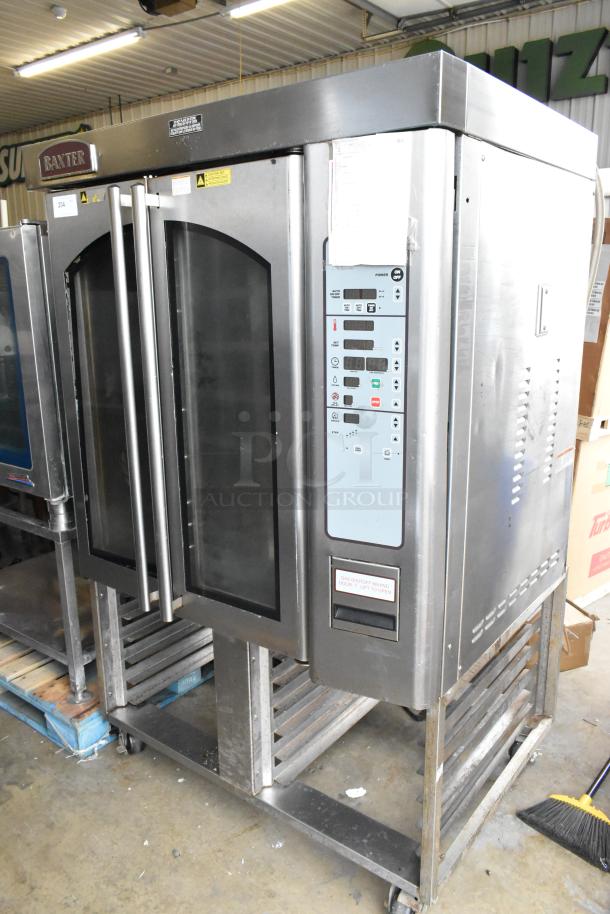 Baxter OV310G stainless steel commercial gas-powered mini rotating rack oven on dual pan rack with casters, excellent condition.