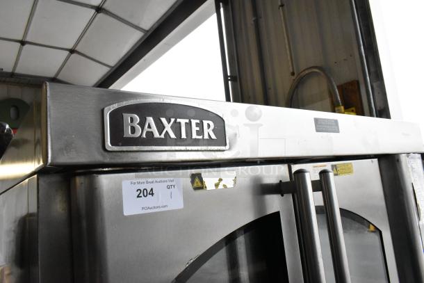 Baxter OV310G stainless steel natural gas mini rotating rack oven with dual pan rack and commercial casters, labeled "Baxter".