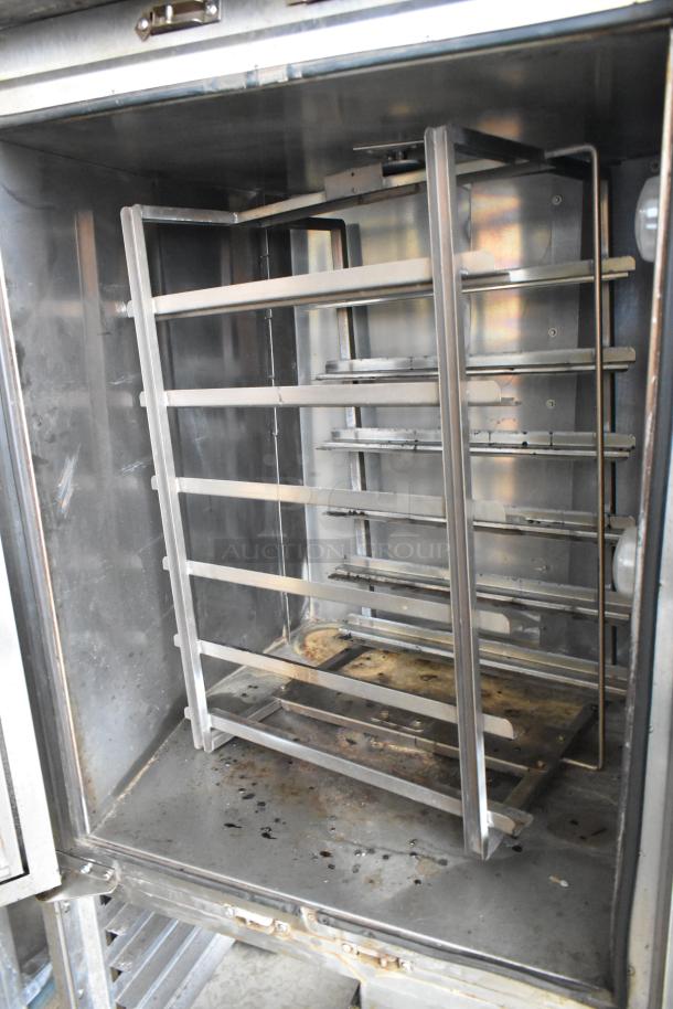 Baxter OV310G stainless steel commercial natural gas mini rotating rack oven with dual pan rack on casters, used condition.