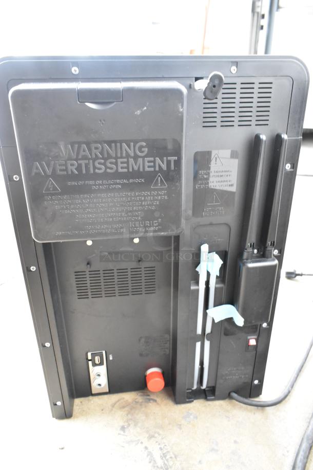 Keurig K4500 coffee machine back view showing warning labels and connections. Model K4500, 120V, 1 Phase.