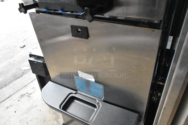 Taylor C723-33 stainless steel soft serve ice cream machine, water-cooled, 2 flavors with twist, on commercial casters.
