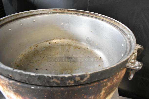 RiceMaster Rice Cooker interior in used condition, showing signs of wear and discoloration. No visible labeling.