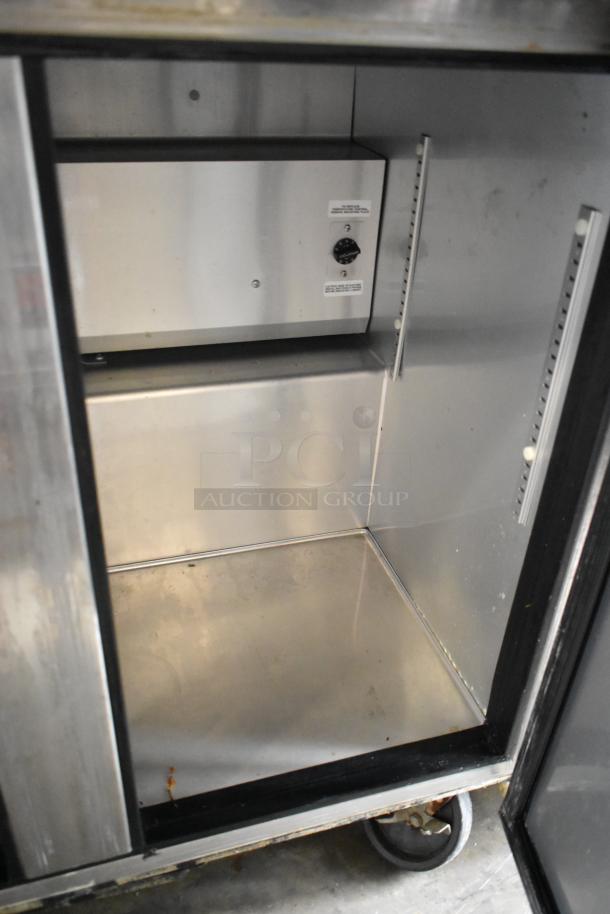 2016 True TWT-36 Stainless Steel 2-Door Cooler, commercial casters, 115V, 1 phase, interior shelves, good condition.
