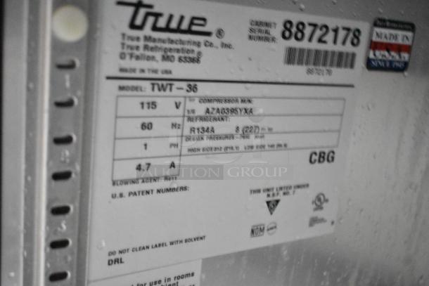 2016 True TWT-36 Stainless Steel 2 Door Work Top Cooler, 115V, 1 Phase, commercial casters, label showing model details.