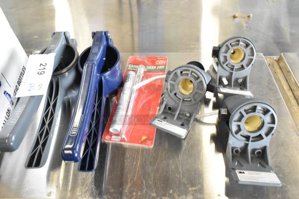 Assorted items including manual juicers, 3M head assemblies, and a CDN deep fry thermometer in packaging.