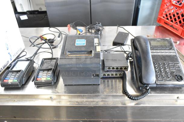 Epson receipt printer, 2 PAX S300 readers, 2 Netgear ProSafe switches, corded telephone. Mixed electronics lot.