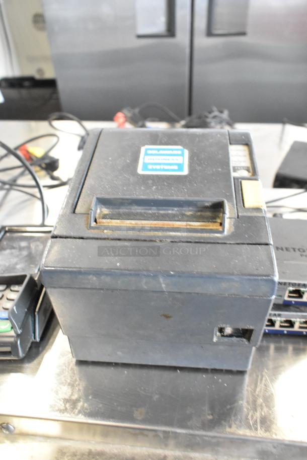 Epson receipt printer, Delaware Business Systems label, visible wear. PAX S300 card readers, Netgear switches, corded phone included.