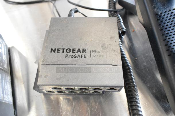 Netgear ProSafe Plus Switch GS105E, showing connectivity ports, part of auction lot with Epson printer and more.