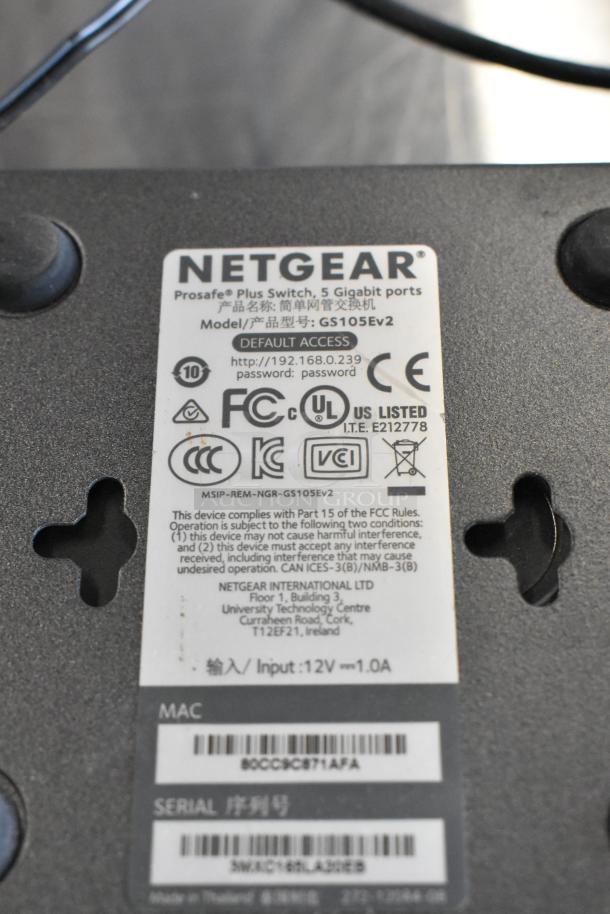 Netgear Prosafe Plus Switch GS105Ev2 label with model, FCC compliance, and serial numbers visible.