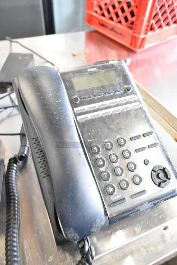 Alt text: Black NEC corded telephone with keypad, slightly worn condition, part of a 6-item auction including a receipt printer and card readers.