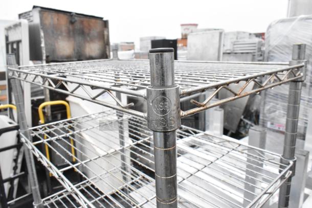 Two chrome finish wire shelves, sizes 14x24x31 and 14x24x59, featuring NSF marking, visible rust and warehouse setting.