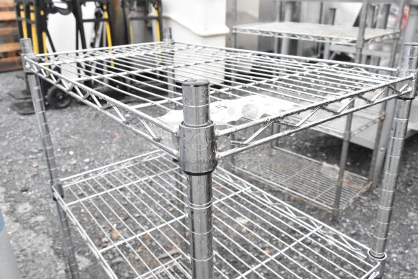 Two chrome finish wire shelves, sizes 14x24x31 and 14x24x59. Buyer must dismantle and arrange shipping.