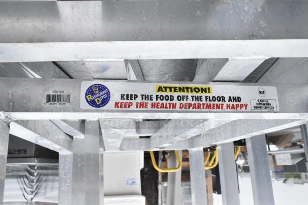 Three metal dunnage racks with a 2,000 lb capacity label, featuring Restaurant Depot branding and safety notice.