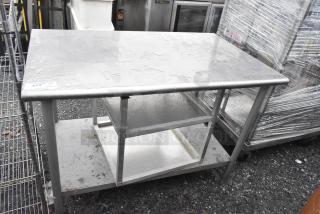 Stainless steel table with under shelf and equipment stand, fair condition, ideal for commercial kitchen use.