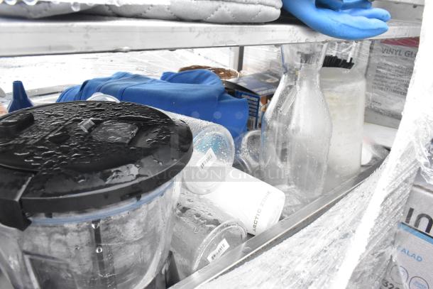 Chrome finish shelving unit with contents including air pots, bottles, and containers. Buyer must dismantle. Contents visible under plastic wrap.