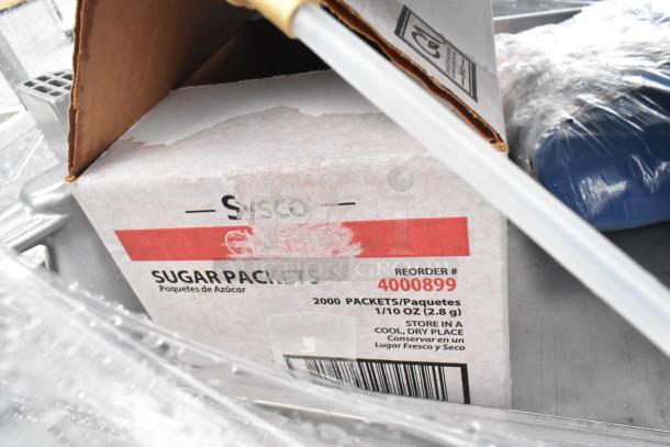 Chrome shelving unit with contents, including Sysco sugar packets box. Buyer to dismantle. Consider freight for shipping.