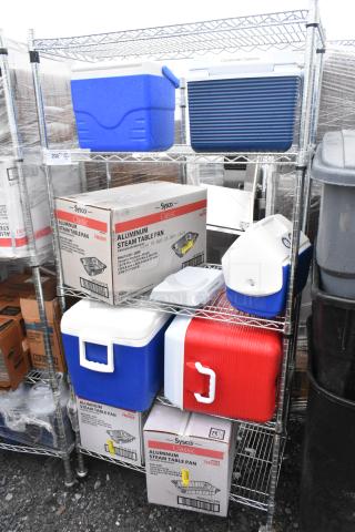 Chrome finish 5-tier wire shelving unit with portable coolers and Sysco steam table pans. Buyer must dismantle for shipping.