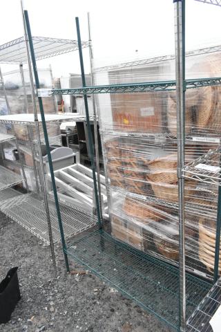 Green finish 2-tier wire shelving unit, dismantle required by buyer, suitable for storage, visible in an outdoor setting.