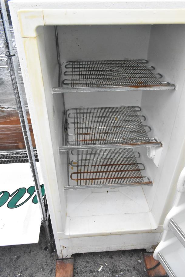 Frigidaire MFU09M2GW0 single door reach-in freezer interior, showing shelves and white finish. Some rust visible. 115 volts, 1 phase.