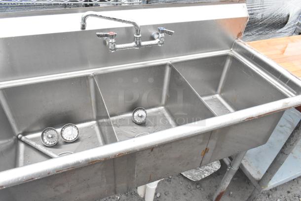 Stainless steel 3 bay sink with left side drain board, faucet, and handles. Used condition. Ideal for commercial kitchens.